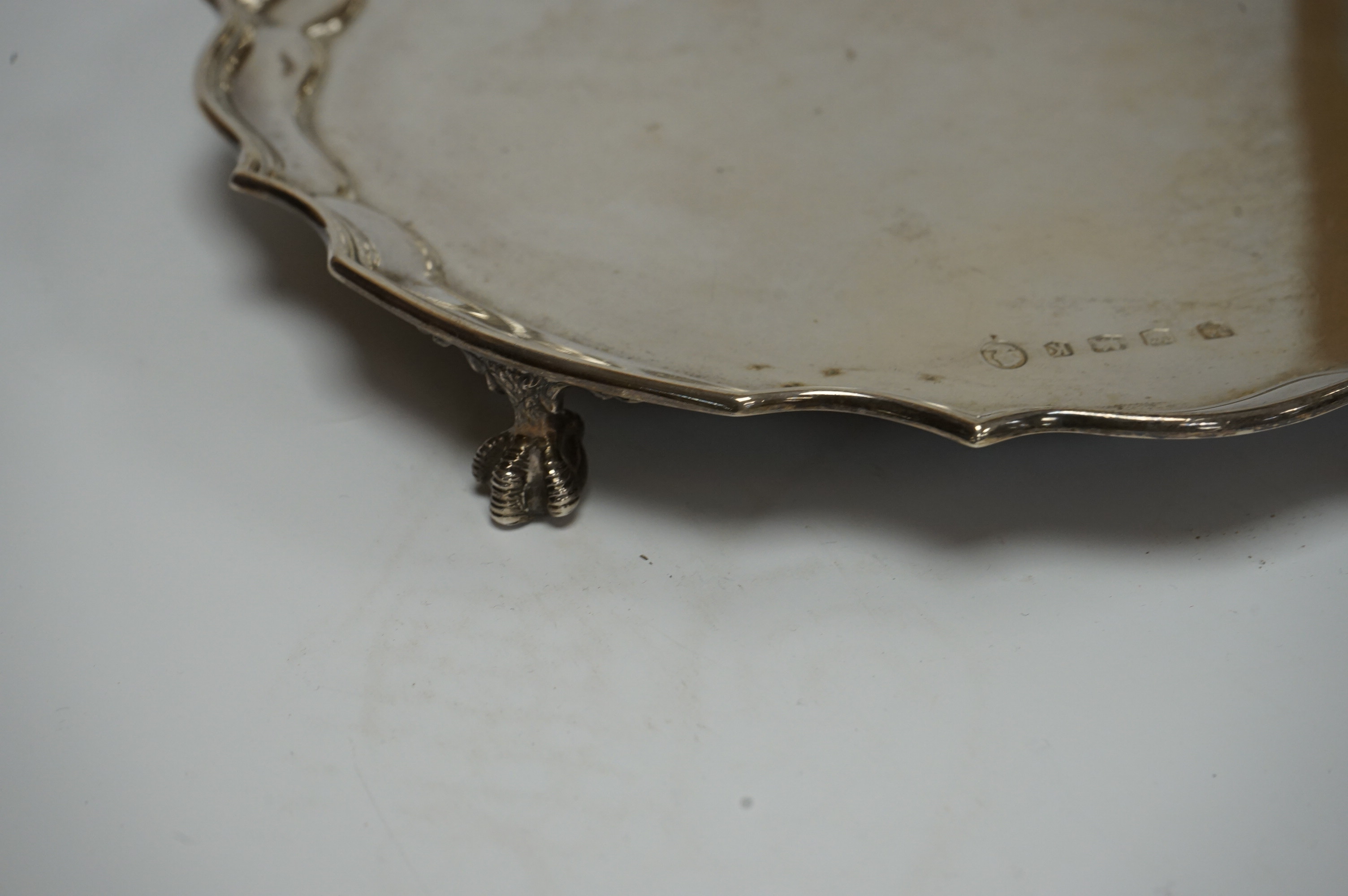 An Elizabeth II silver salver, by Poston Products Ltd, Sheffield, 1952, 25.4cm, with pie crust border, on four claw and ball feet, 17oz. Condition - fair to good